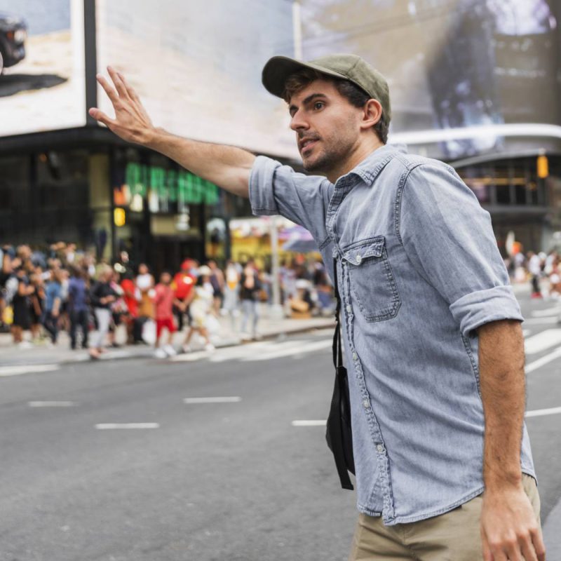 happy-couple-choosing-car-in-dealership-salon-woman-pointing-on-car-e1616394658847-1
