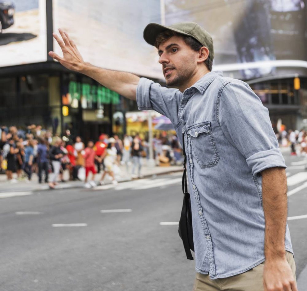 happy-couple-choosing-car-in-dealership-salon-woman-pointing-on-car-e1616394658847-1
